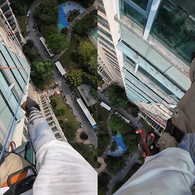 男子在22楼高空作业 熊孩子摇绳捣乱